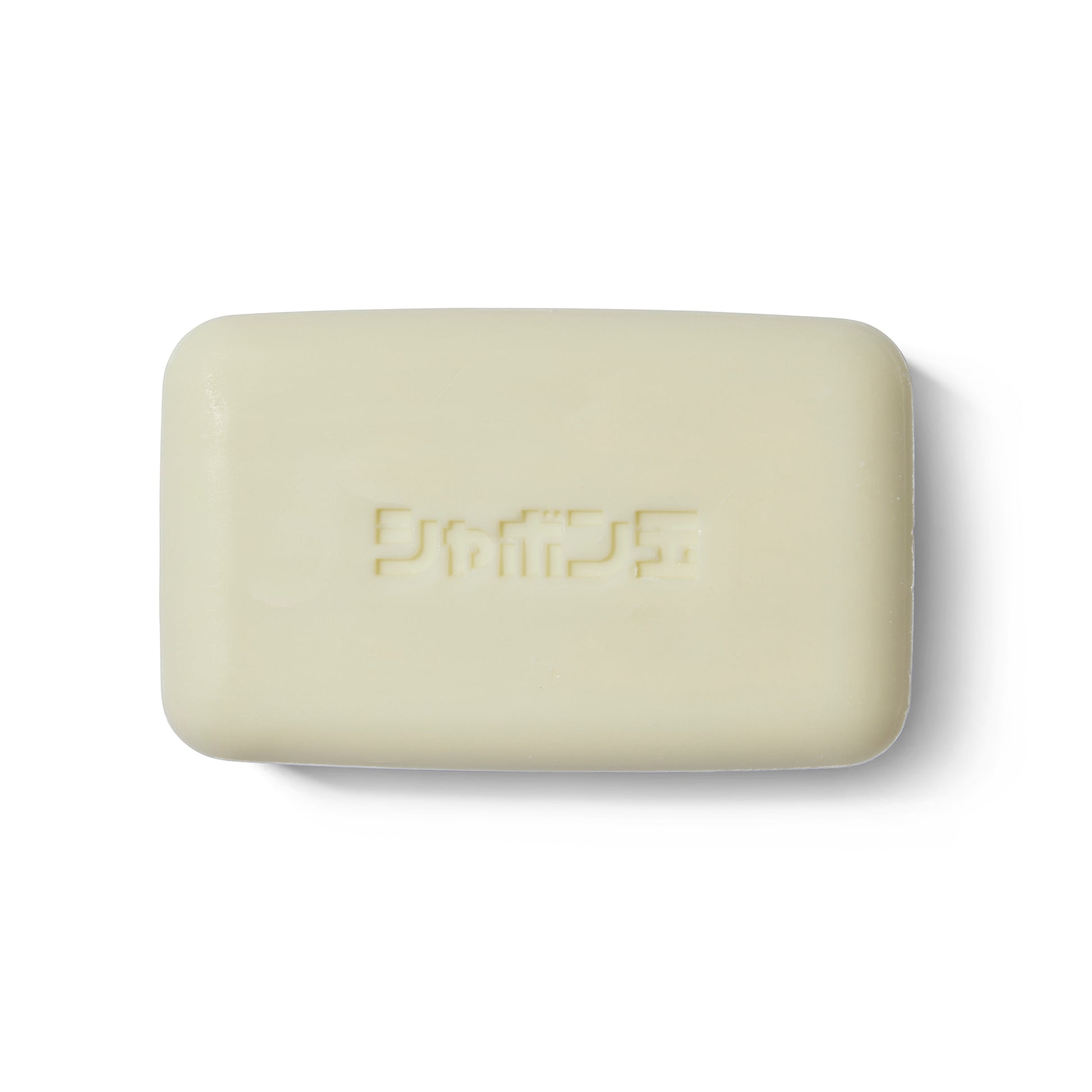 The Takeda Brush Purely Soap out of its outer packaging. There is Japanese writing embossed into the soap.