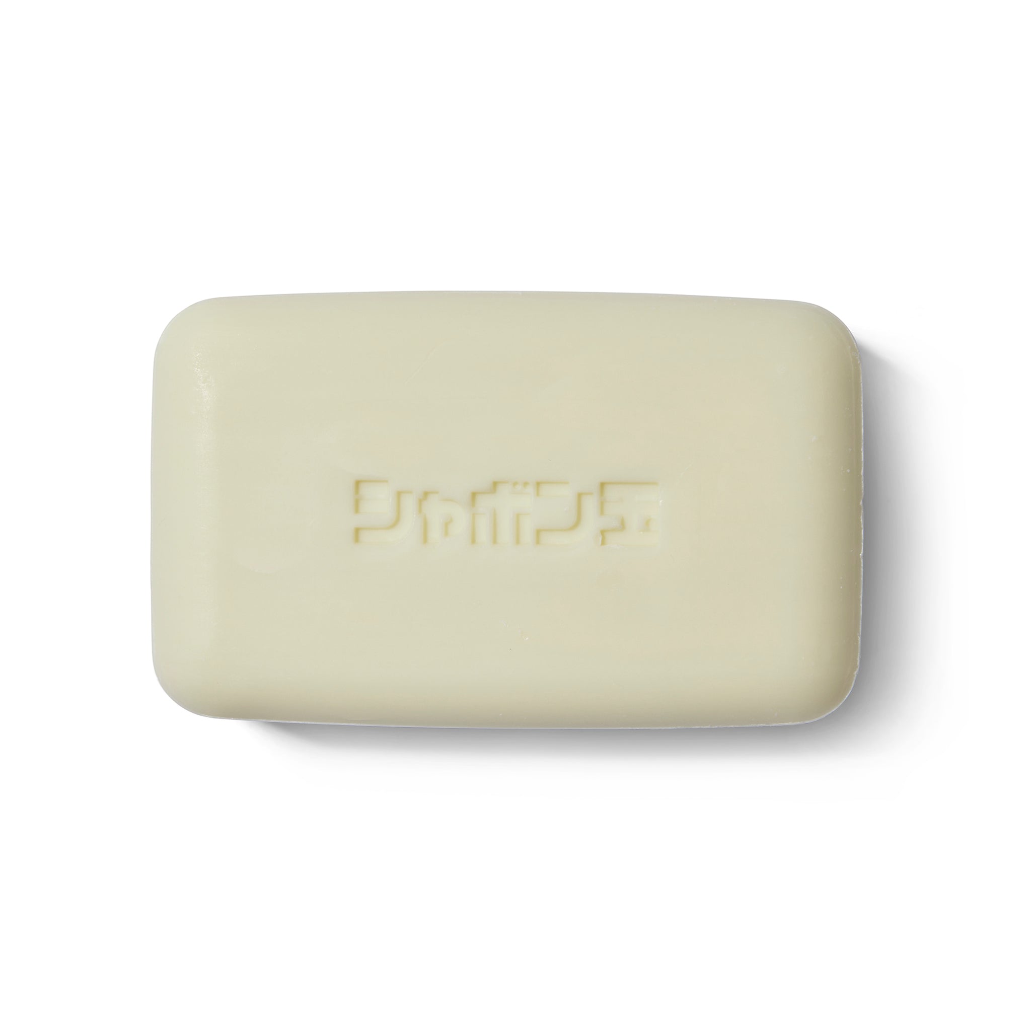 The Takeda Brush Purely Soap out of its outer packaging. There is Japanese writing embossed into the soap.
