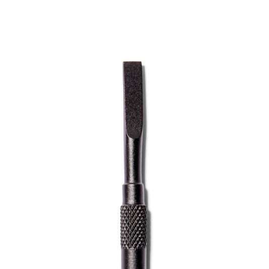 Close up of The Push Back cuticle pusher from ten over ten. This side is squared off on the edges and a matte black.