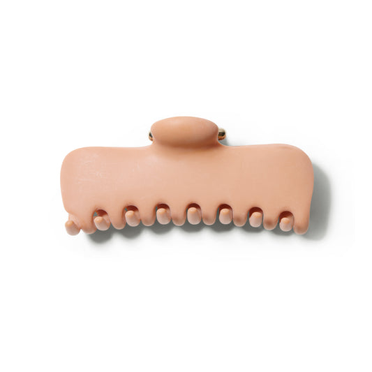 Front view of the Undo 4 inch terracotta colored claw clip with gold hardware.