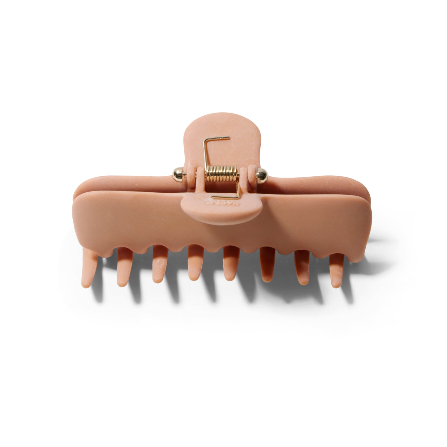 Top view of the Undo 4 inch matte terracotta colored claw clip showing the elegant gold spring.