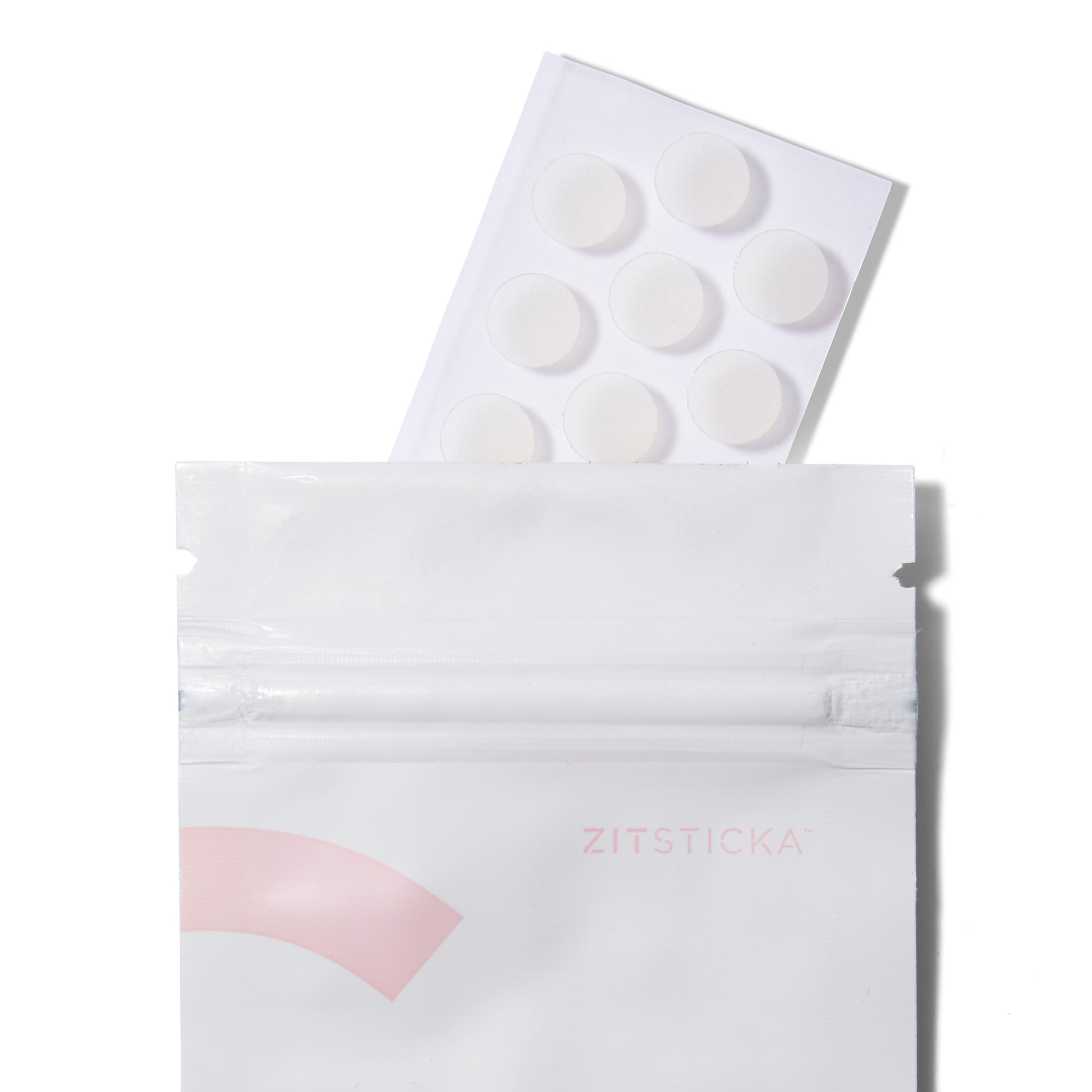Open sachet of Zitstika Goo Getter Spot Clarifying Pimple Patches with the sheet of stickers poking out of the top.