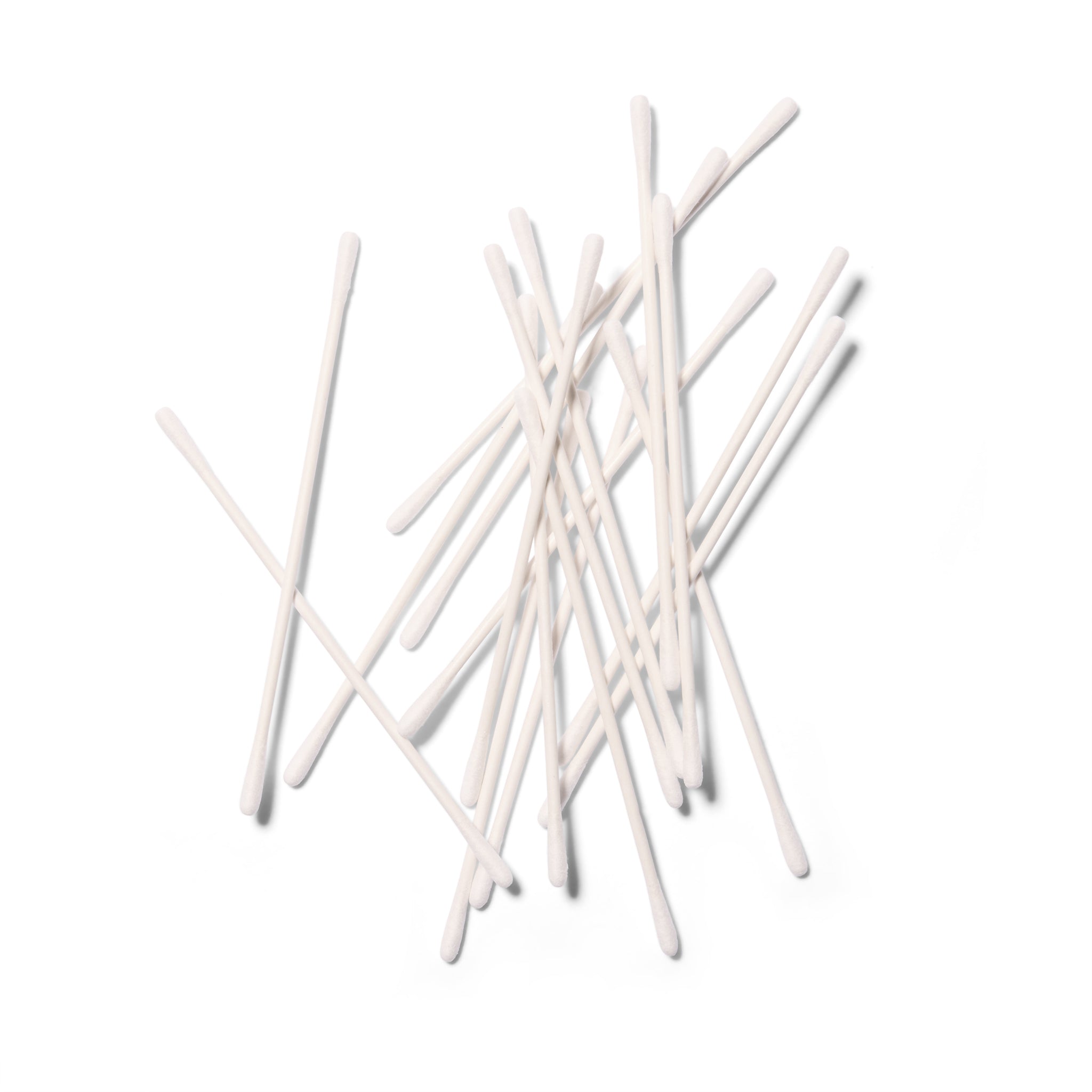 A handful of cotton buds in a haphazard pile on a white background. 