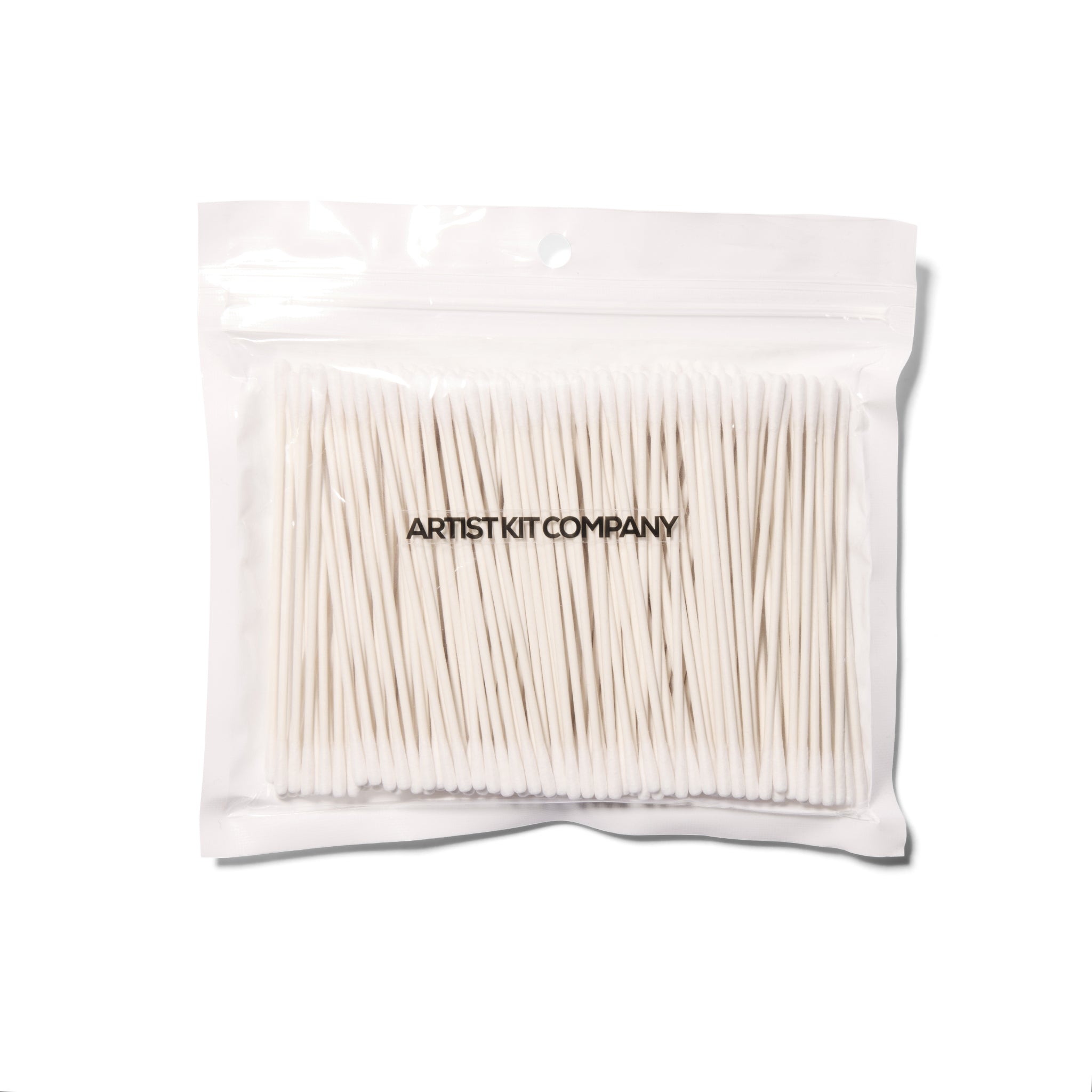 A clear package with small cotton buds in it on a white background.