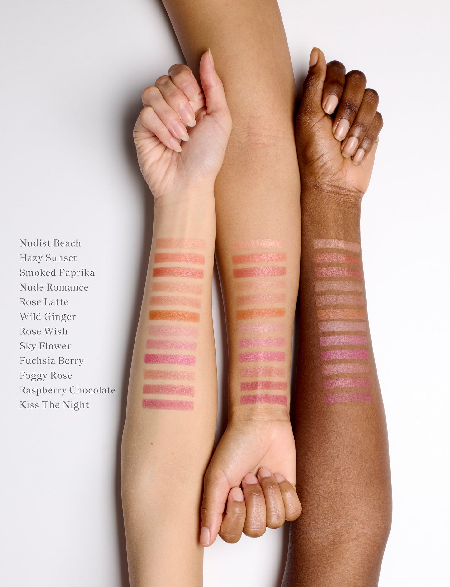 Three arms lined up next to each other with cream blush swatches on the skin. There are twelve swatch stripes on each of the three arms. The arm on the left is fair, the middle is golden and the arm on the right is deep. Their nails are unpainted and their hands are semi-closed in a relaxed state.