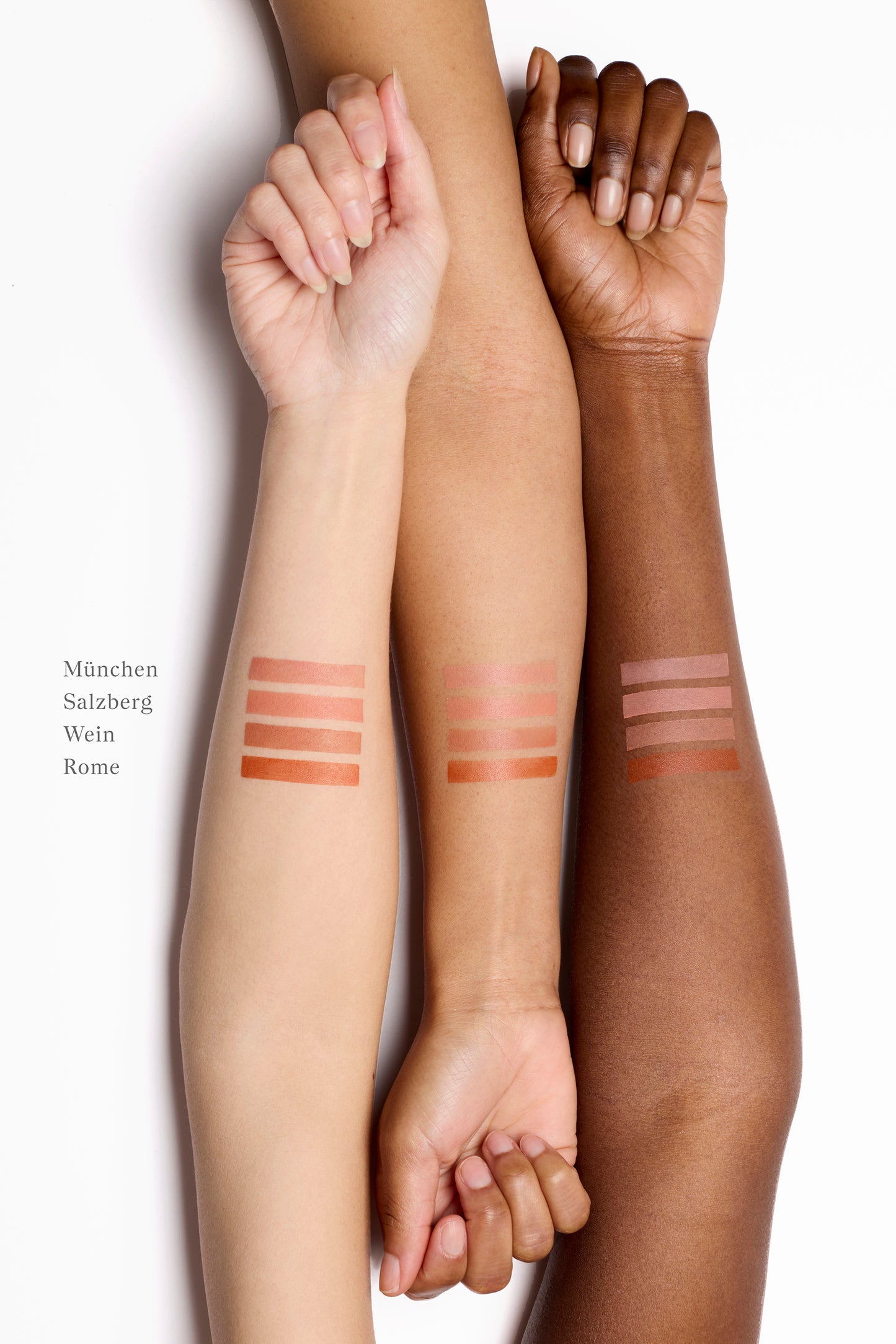 Three arms lined up next to each other with liquid blush swatches on the skin.  There are four swatch stripes on each of the three arms. The arm on the left is fair, the middle is golden and the arm on the right is deep. Their nails are unpainted and their hands are semi-closed in a relaxed state.