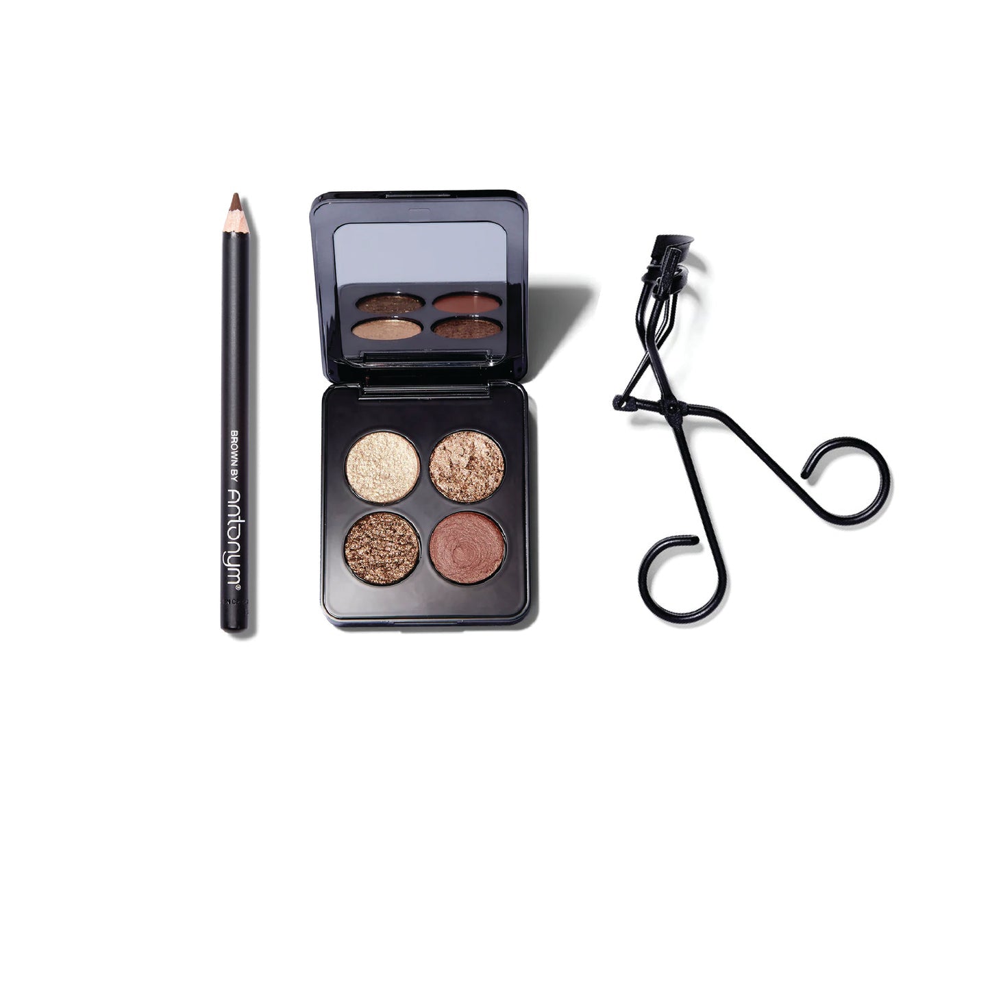 The Antonym brown eyeliner pencil, the ROEN eyeshadow quad with metallic gold and bronze shades, and the matte black metal Surratt Relevee eyelash curler.