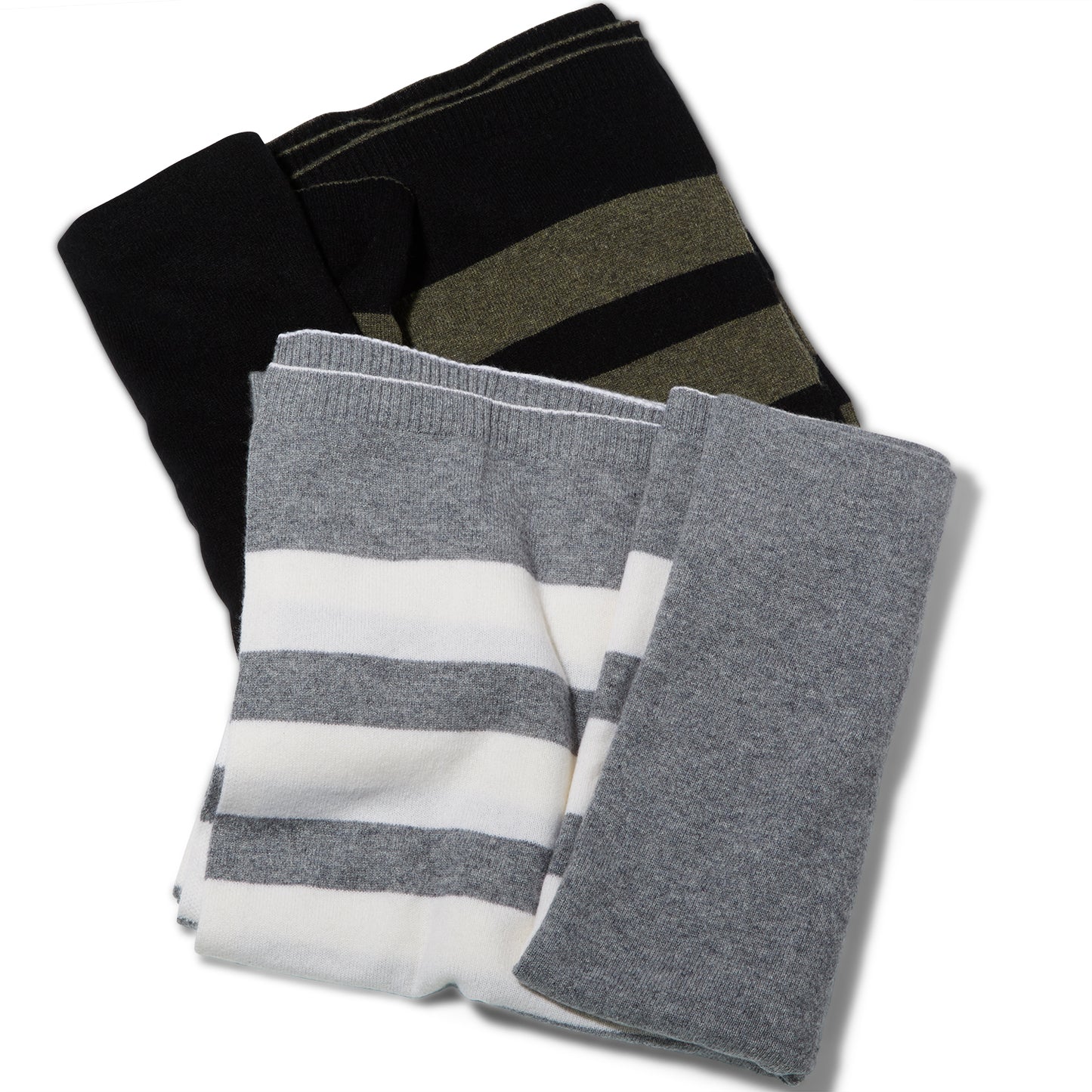 Two Reed Clarke Cashmere Travel blankets. A folded grey blanket with wide white stripes laying partially on top of a black blanket with wide olive green stripes.